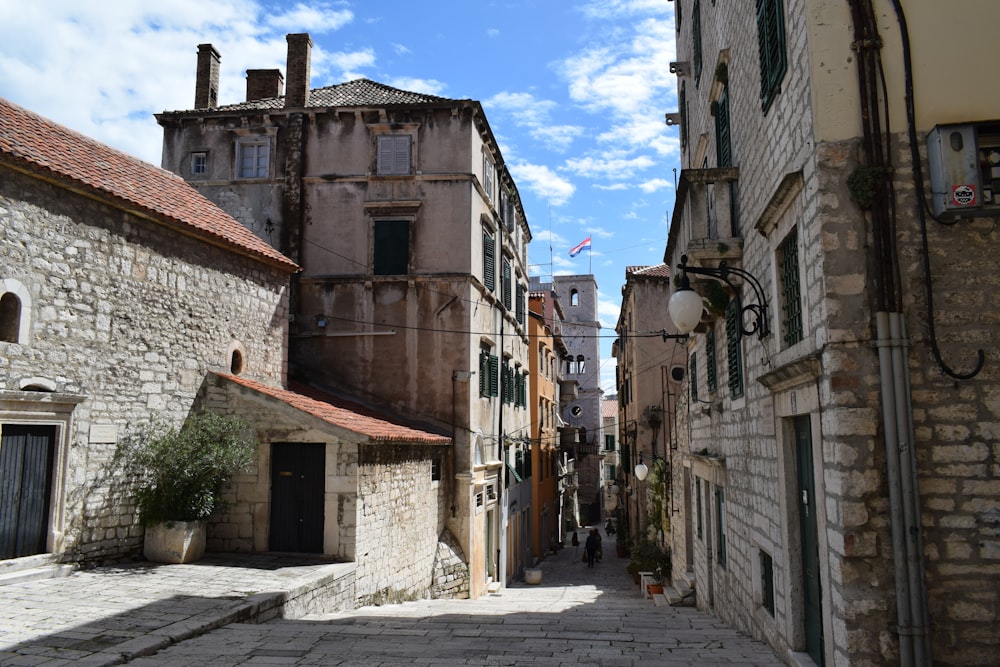 a cobblestone street lined with stone buildings