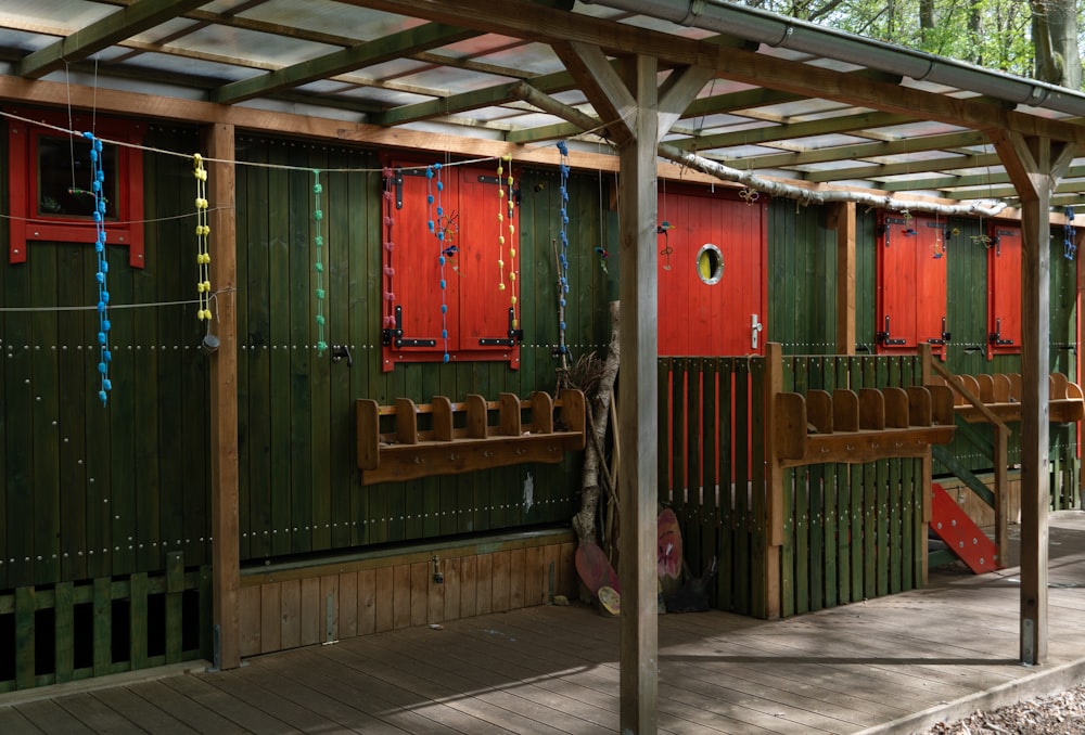 a row of green and red wooden buildings