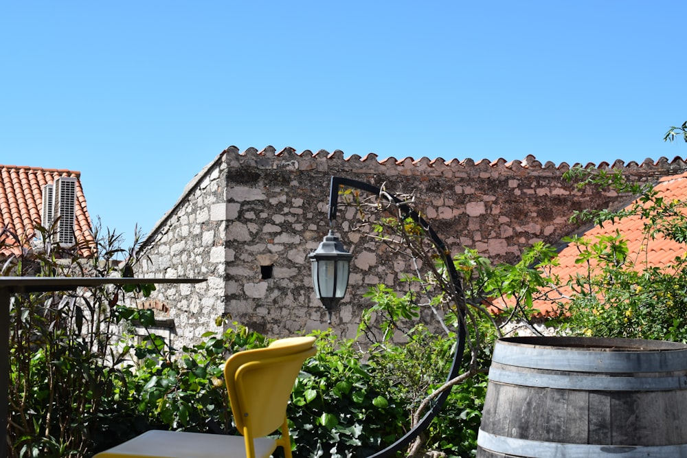 a yellow chair sitting on top of a wooden barrel