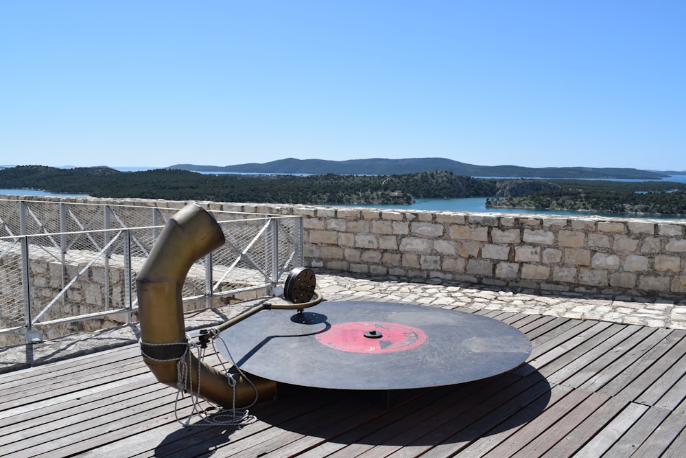 a record player sitting on top of a wooden deck