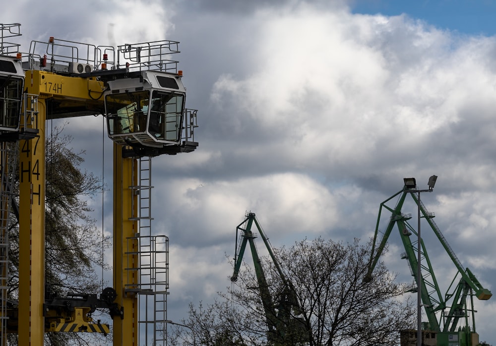 a couple of cranes that are next to each other