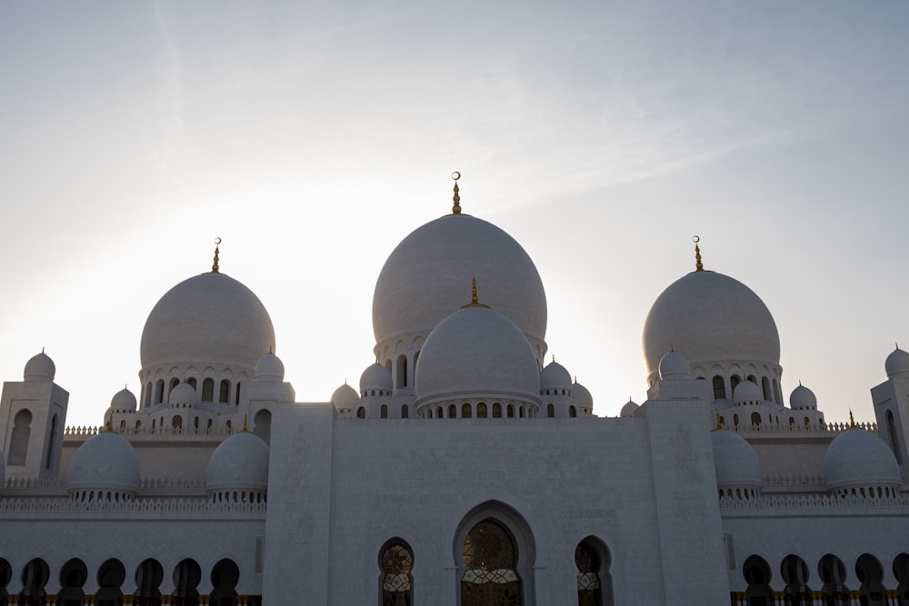 a large white building with two domes on top of it