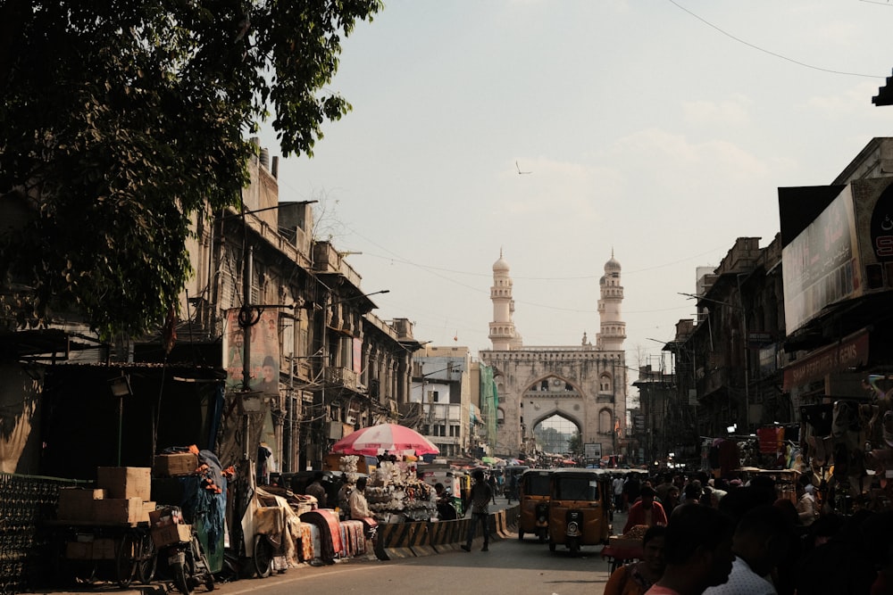 a city street with a lot of people walking around