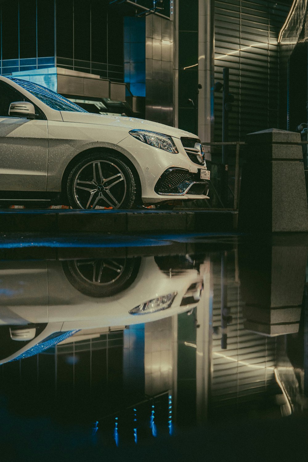 a white car parked in front of a building