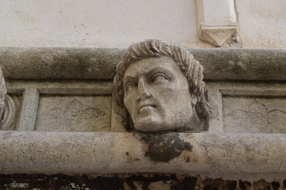 a close up of a face on a building