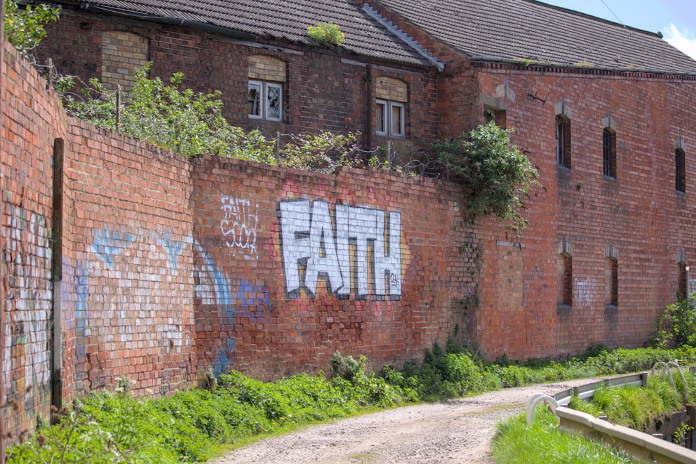 a brick building with graffiti on the side of it