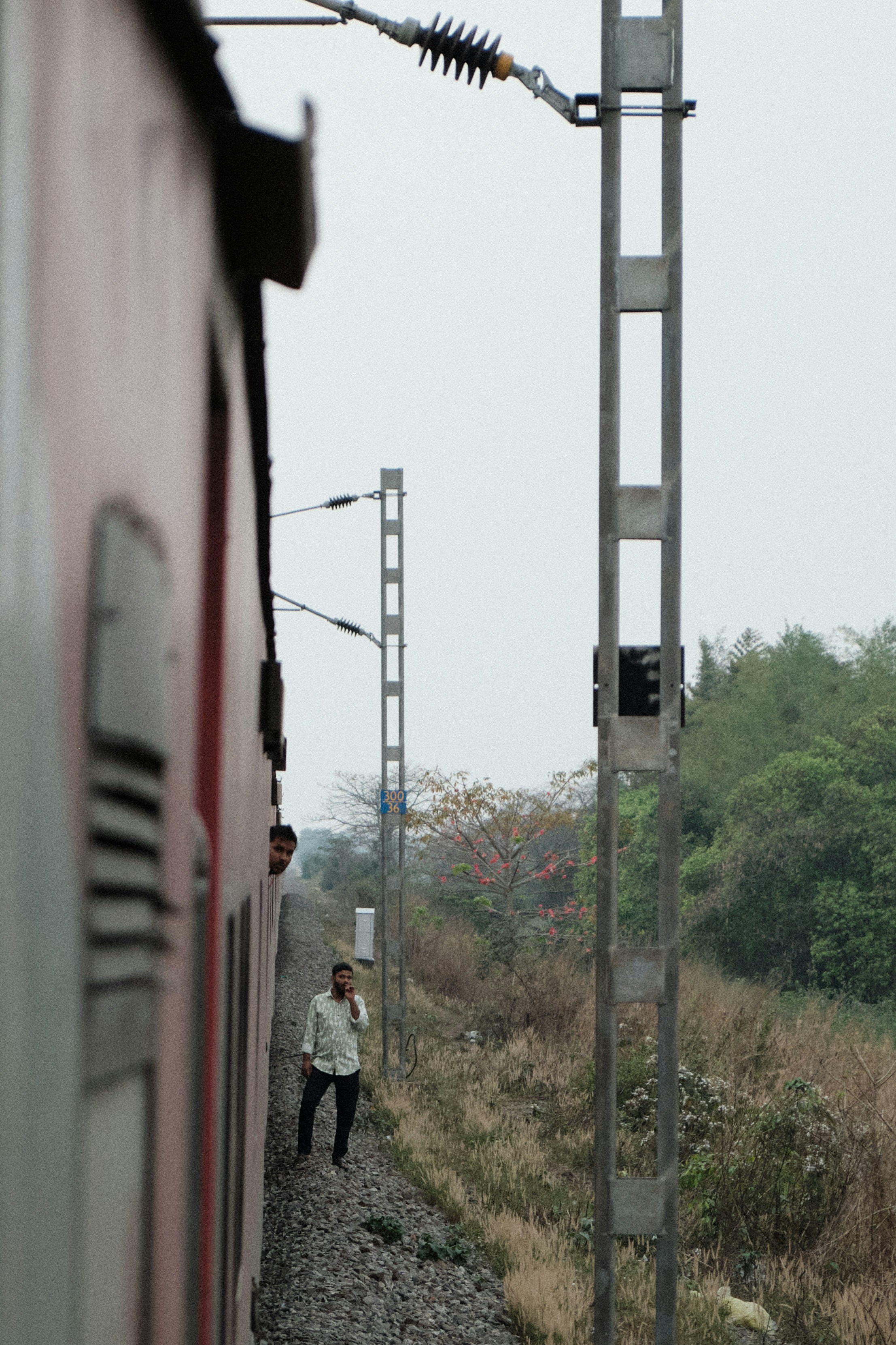 a man standing on the side of a train track