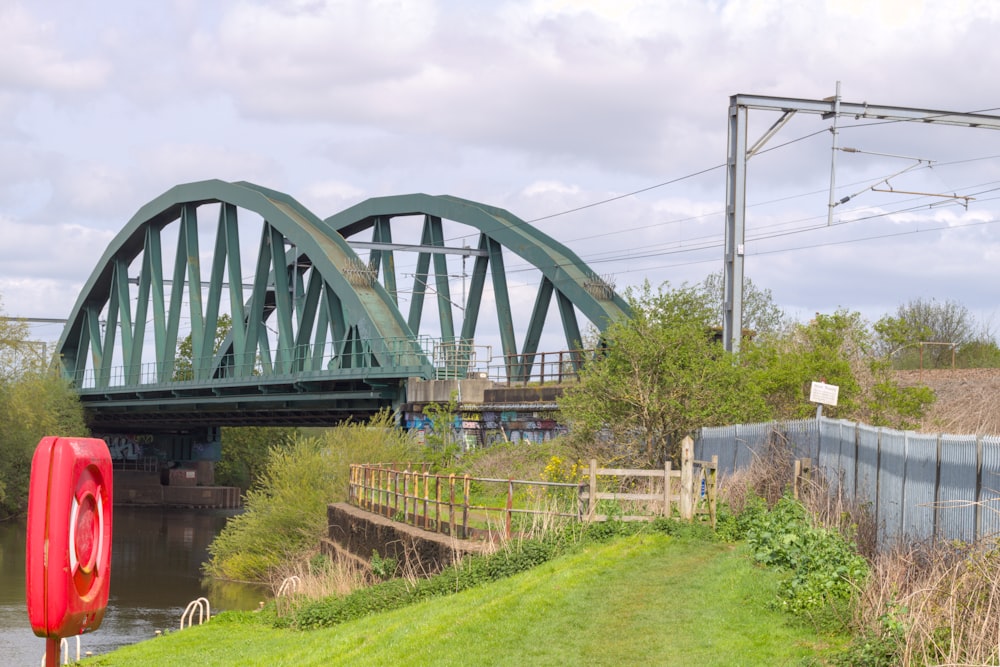 a bridge over a river with a red object in the foreground