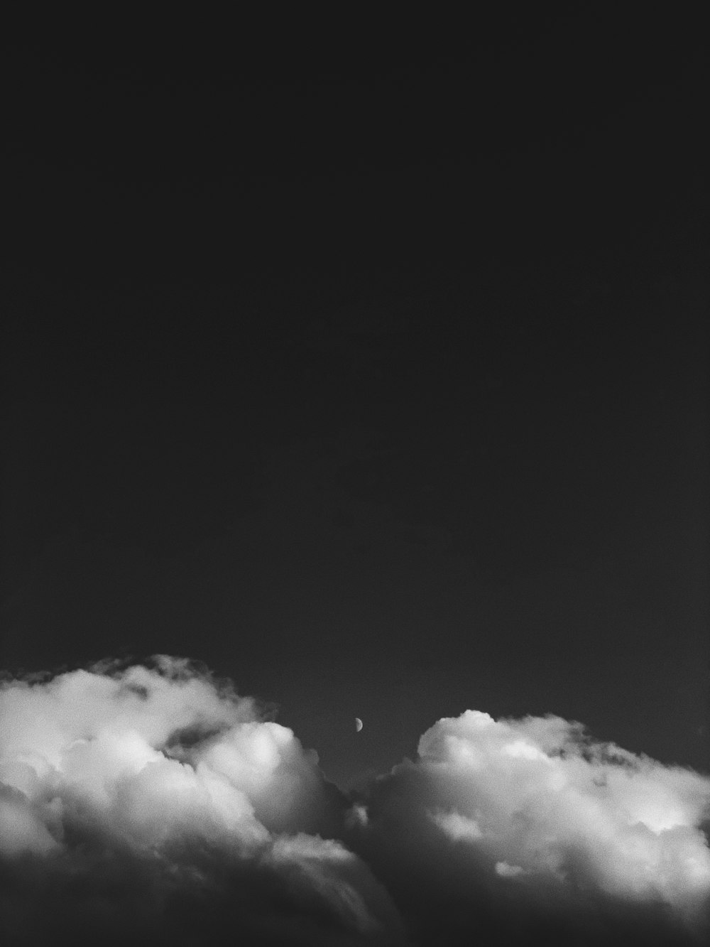 a black and white photo of a plane flying in the sky