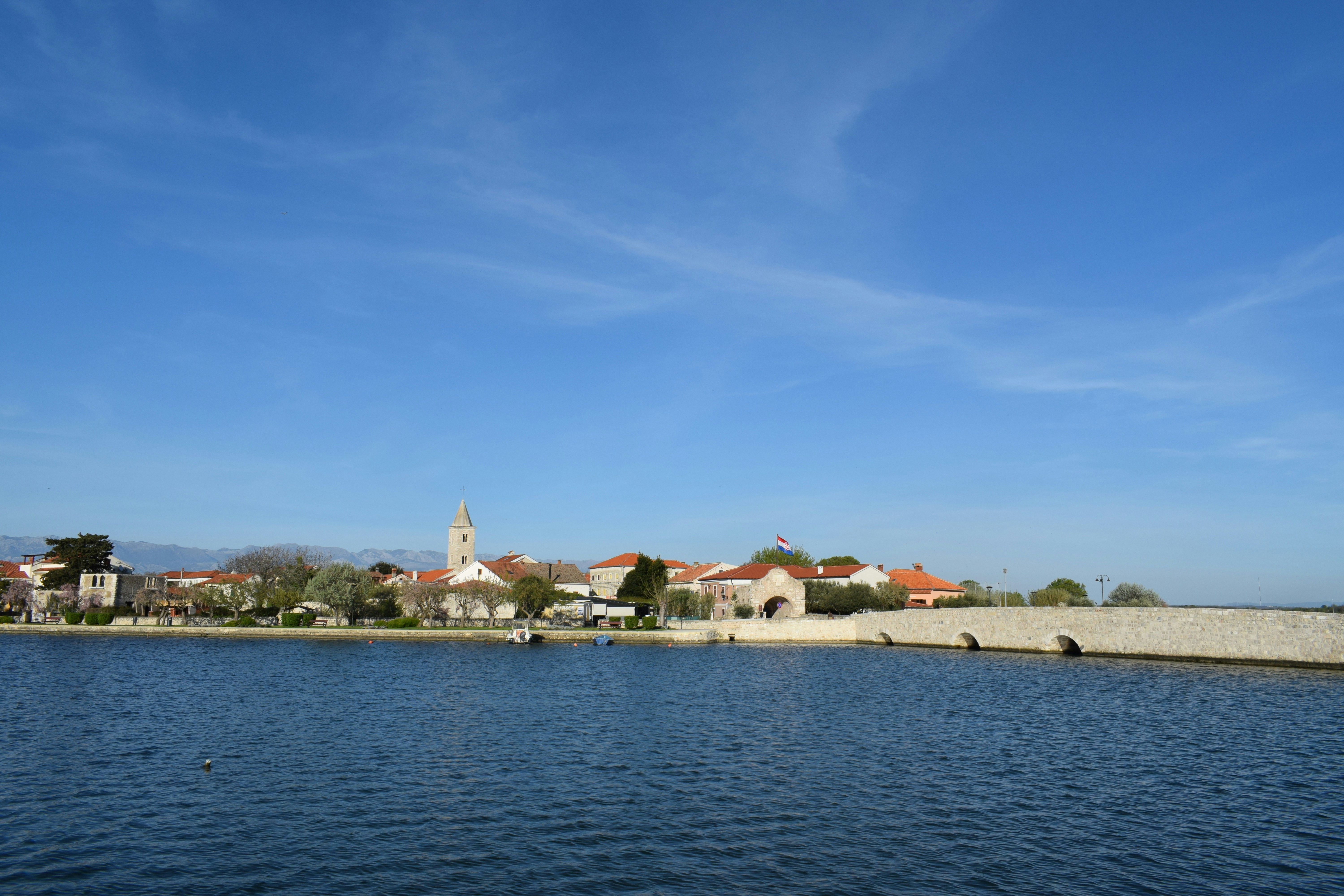 a body of water with houses in the background, Nin, beautiful three thousand years old history town to visit.