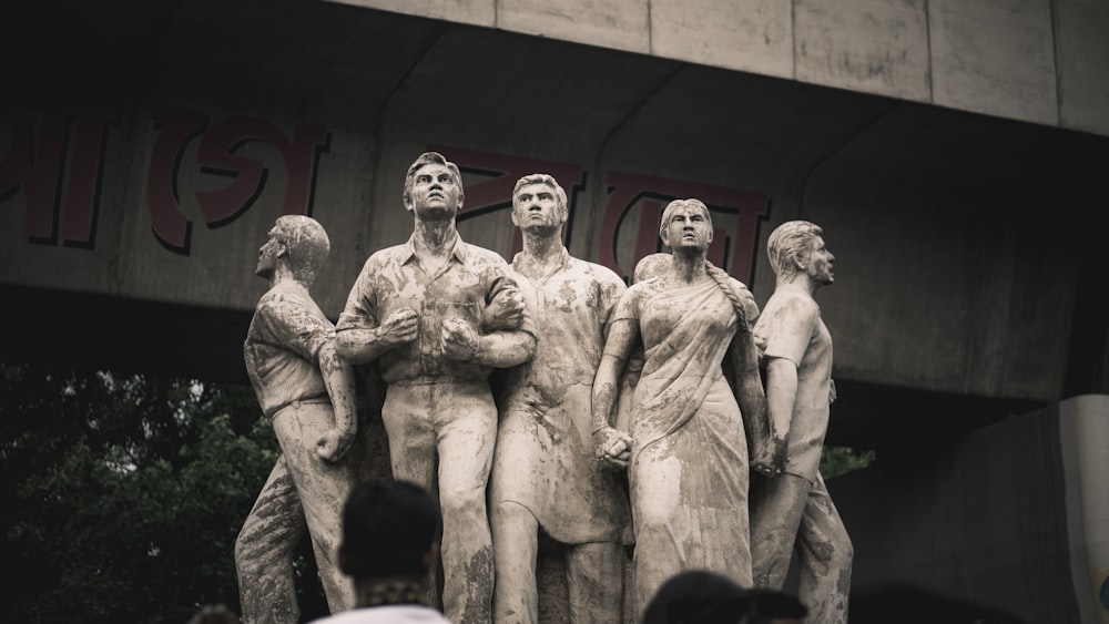 a group of statues in front of a building