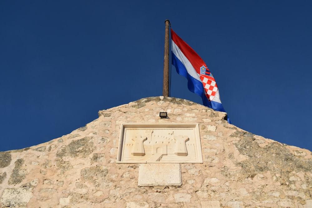 a flag flying on top of a stone building