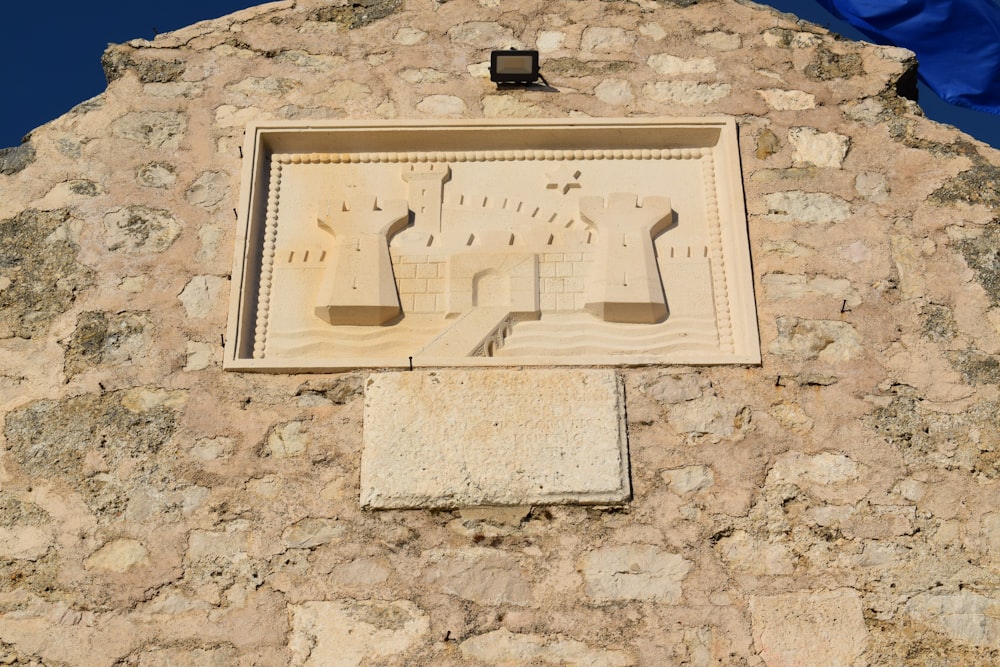 a close up of a stone building with a clock on it