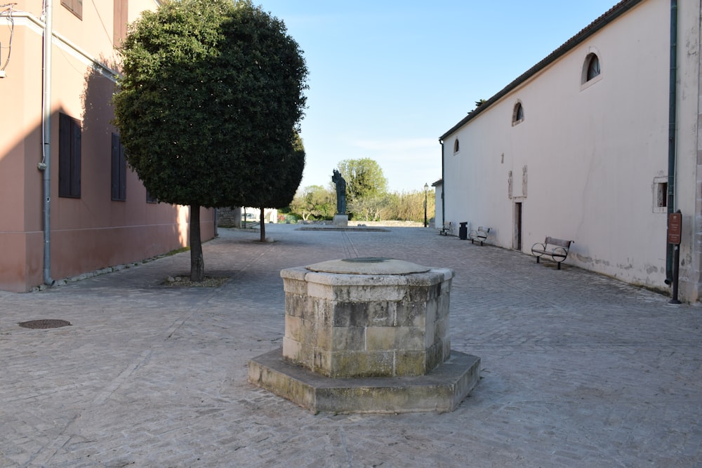 a stone fountain in the middle of a courtyard