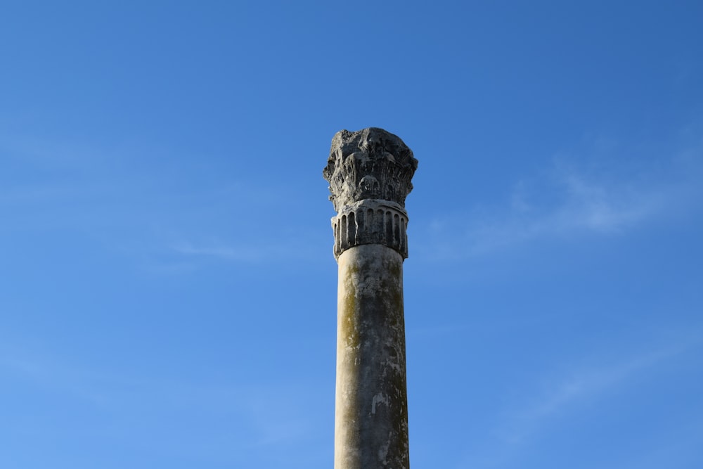 a tall stone pillar with a sky in the background