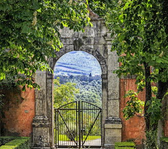 a gate with a mountain view through it
