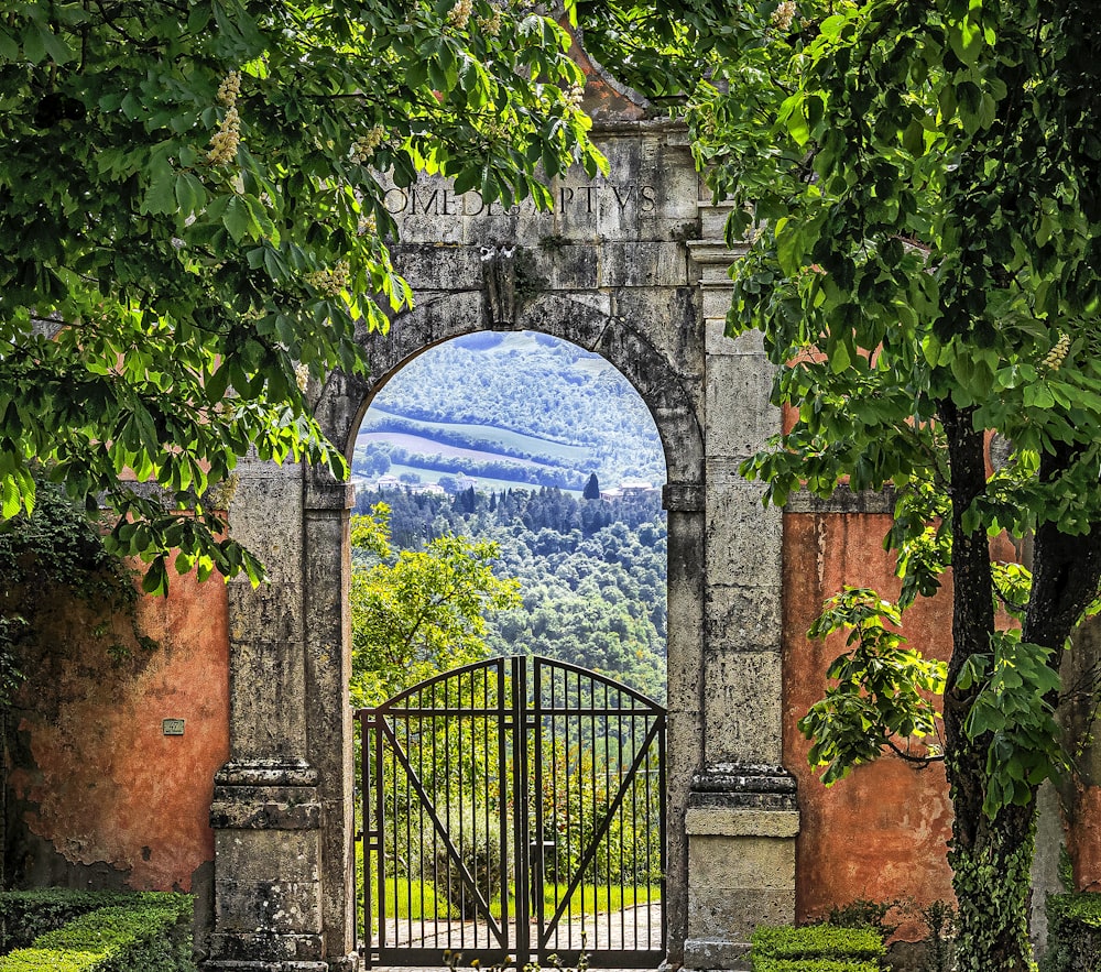 a gate with a mountain view through it