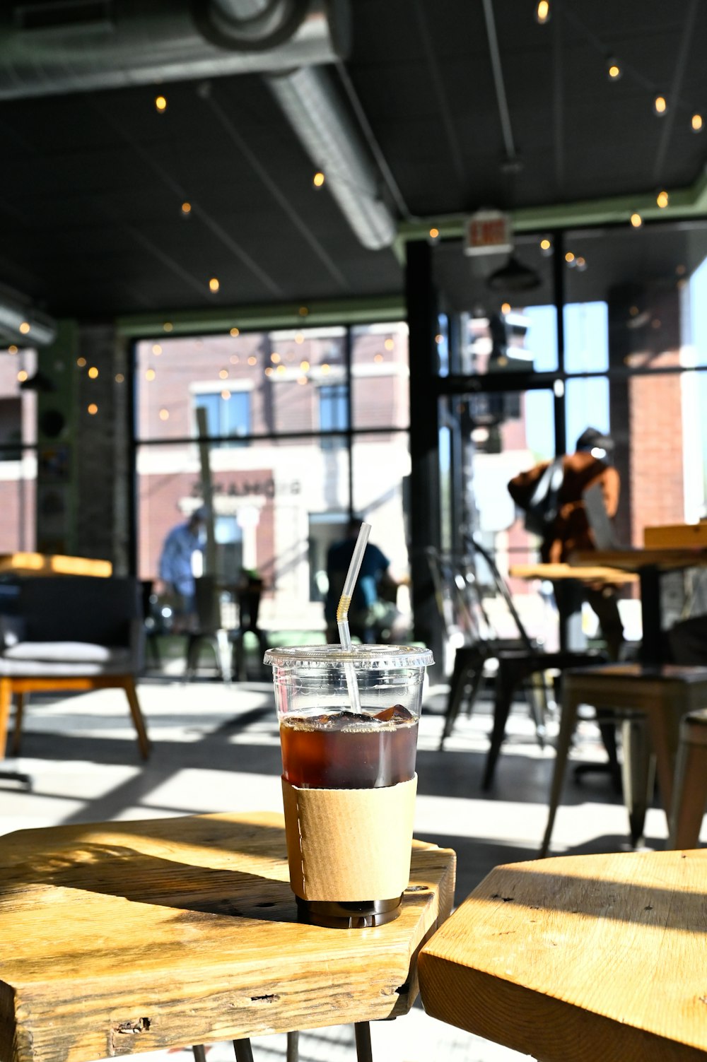 a cup of coffee sitting on top of a wooden table