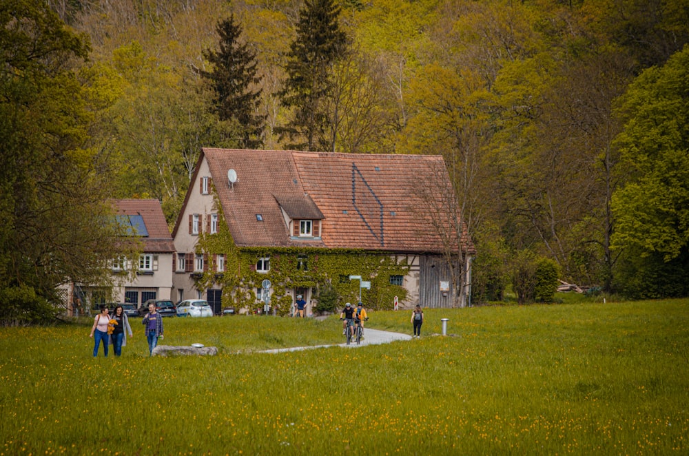 a group of people standing in front of a house