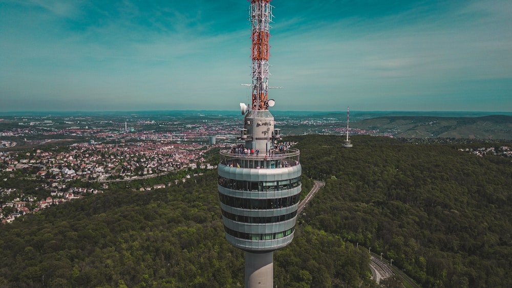 a very tall tower sitting in the middle of a forest