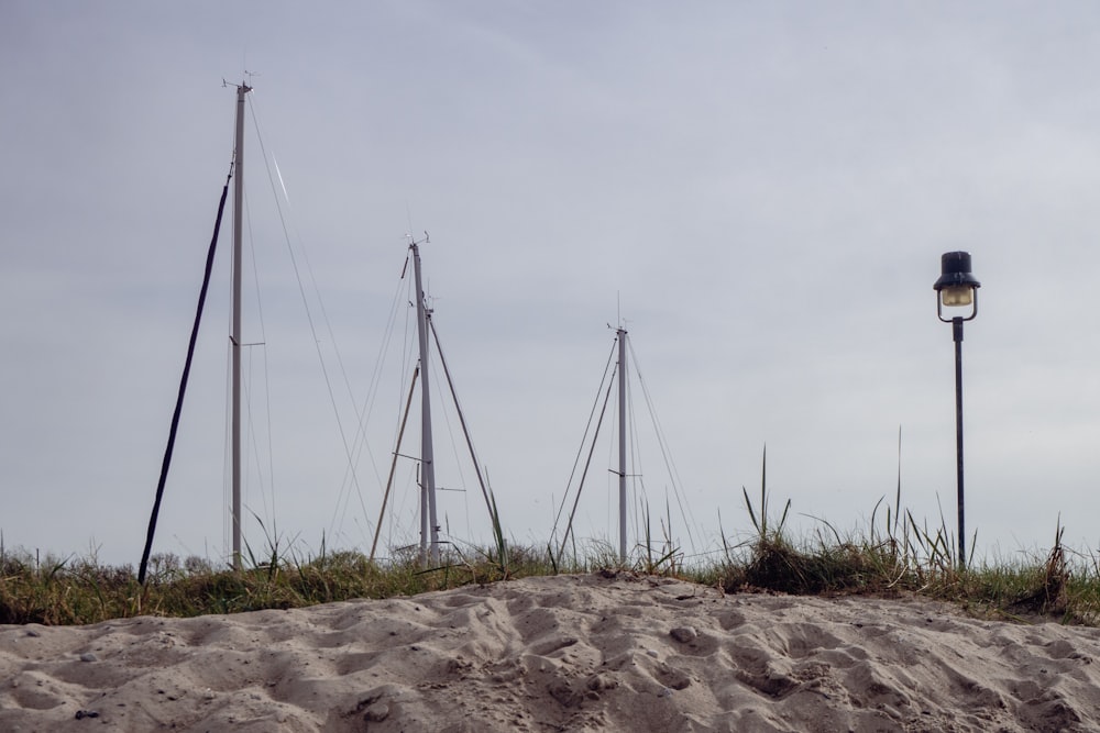 a bunch of sailboats that are sitting in the sand