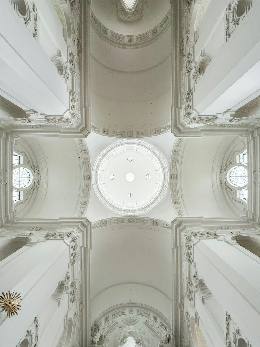 the ceiling of a church with a circular window