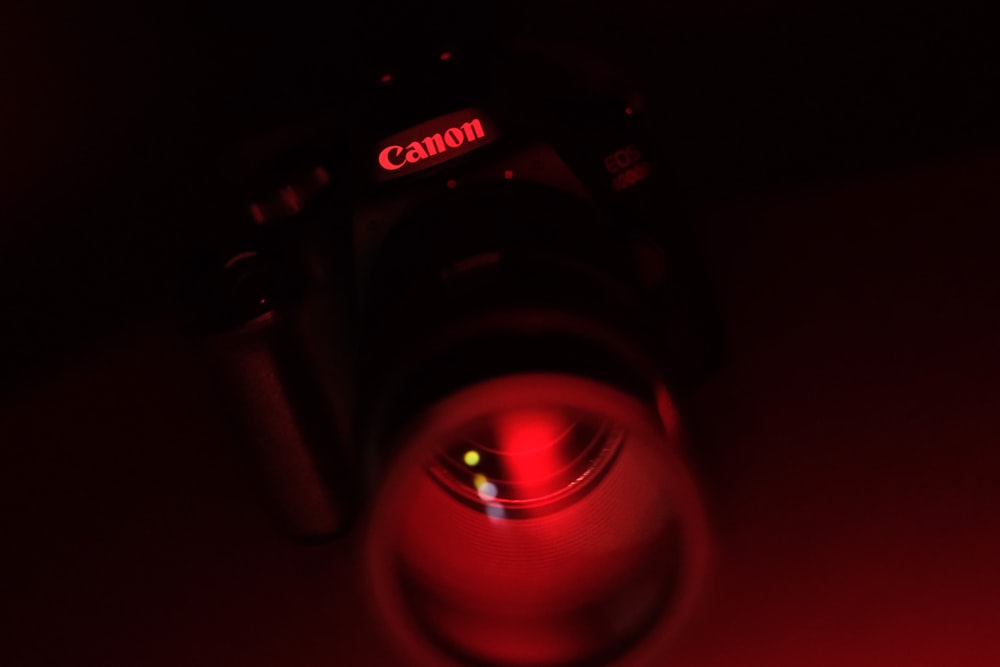 a camera lens with a red light shining on it