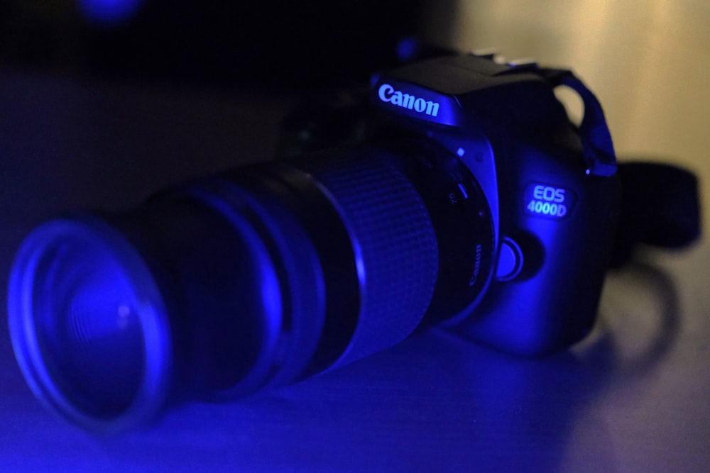 a camera sitting on top of a table next to a blue light