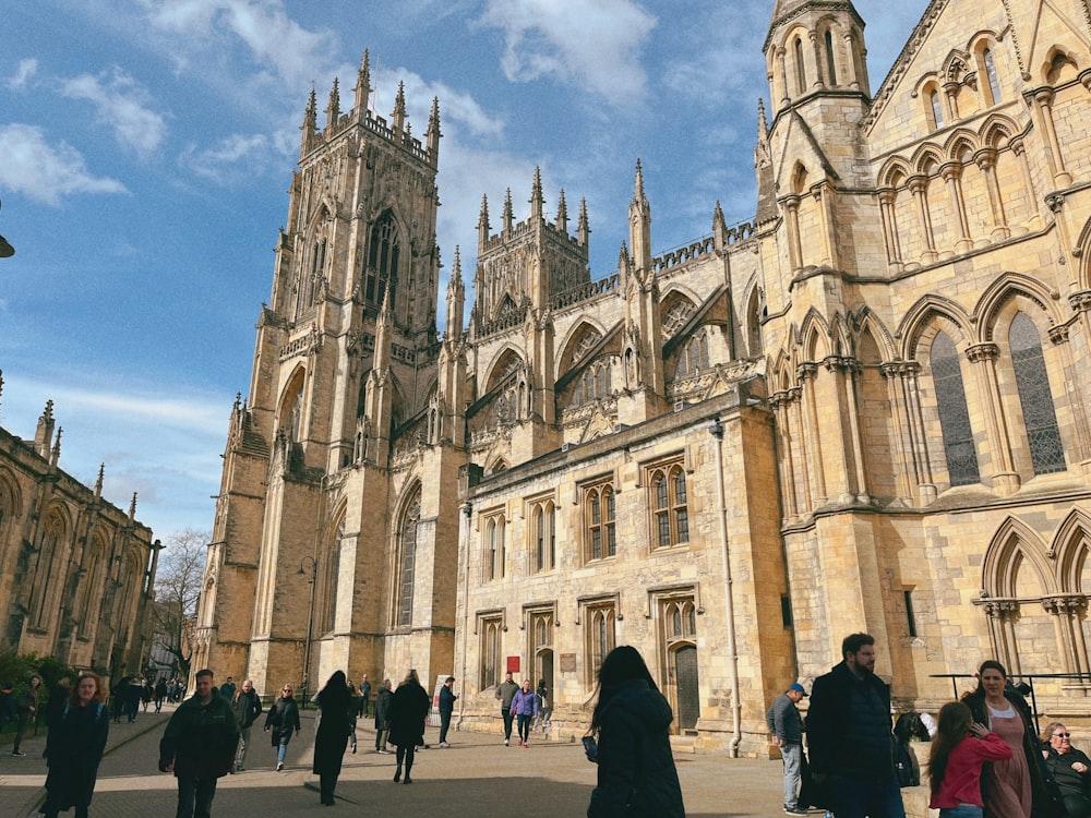 a group of people walking in front of a large building