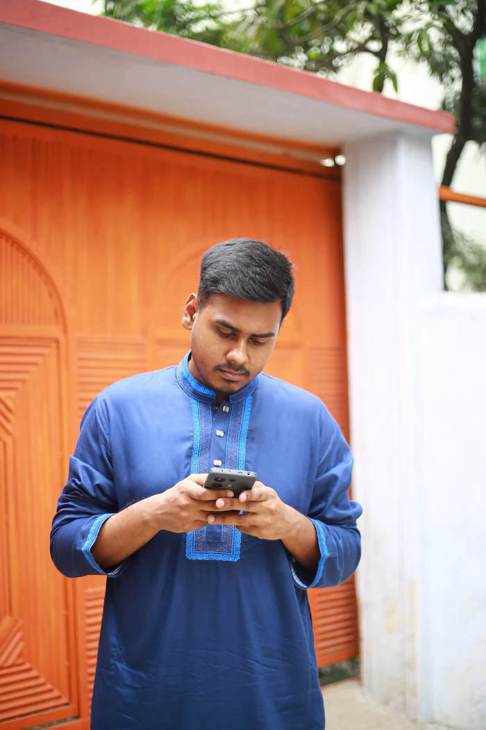 A father reading a message on his phone