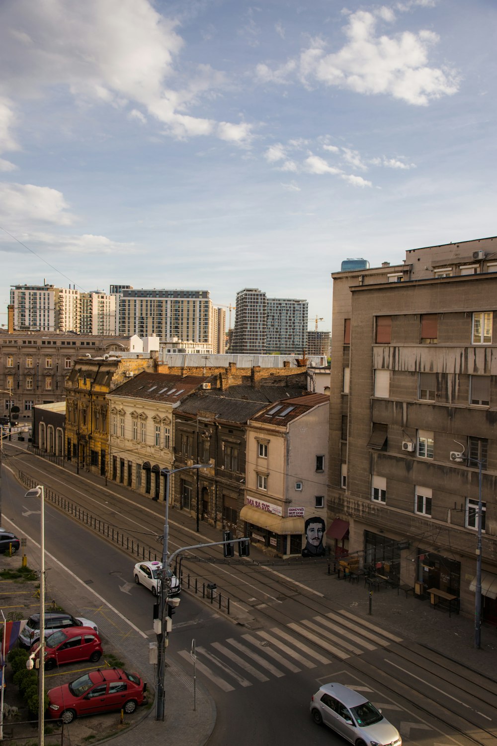 a city street filled with lots of traffic next to tall buildings