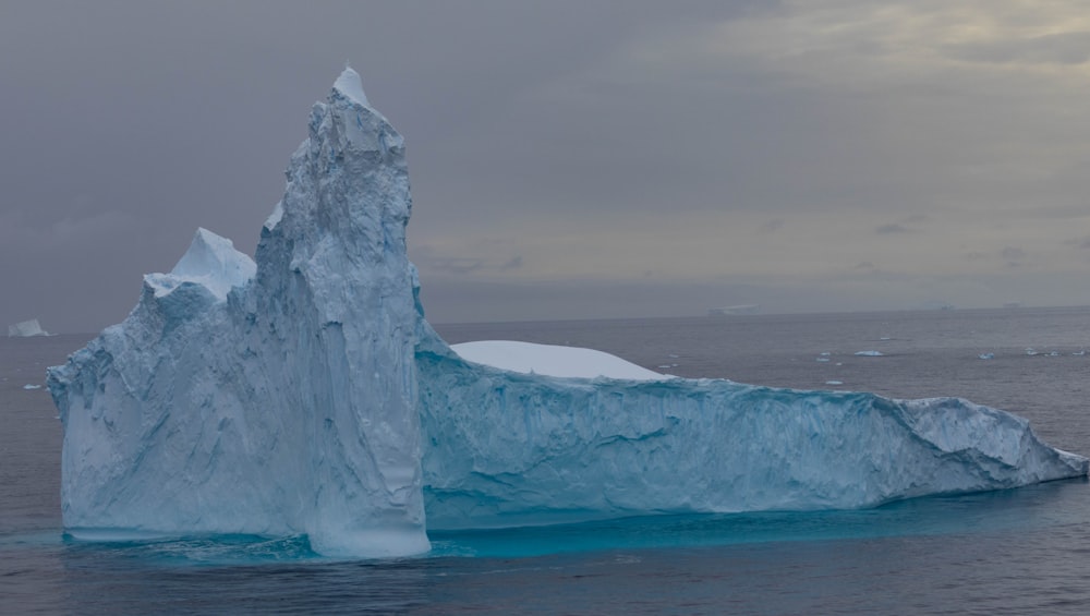 a large iceberg floating in the middle of the ocean