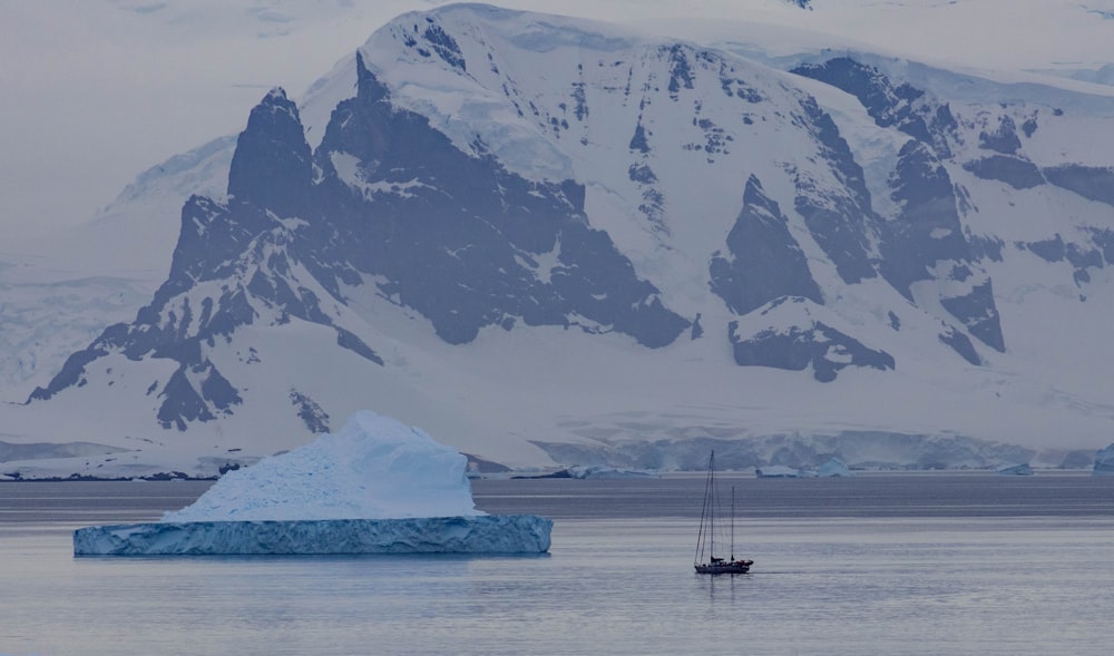 a large iceberg floating in the middle of a lake