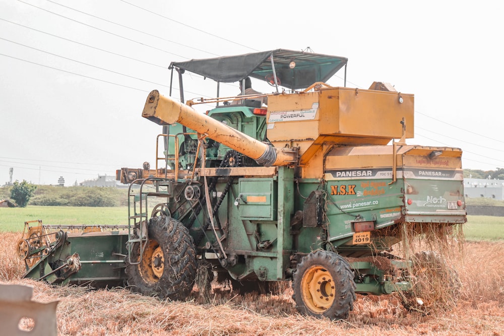 a large green and yellow tractor in a field