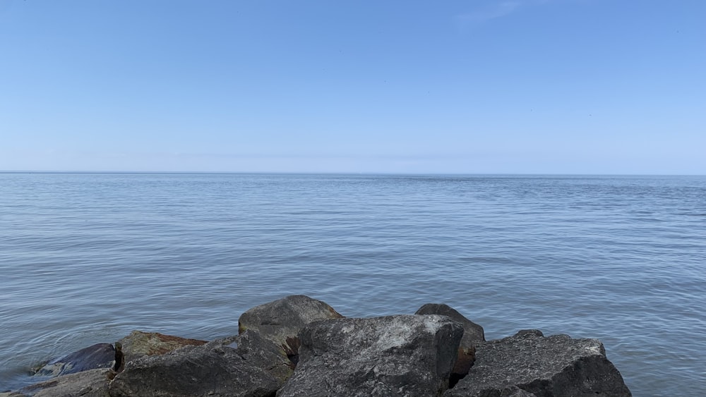 a view of a body of water with rocks in the foreground