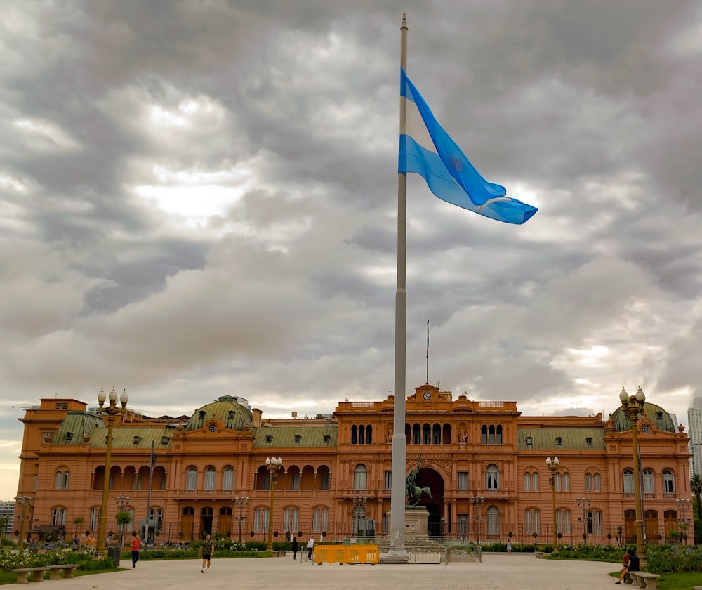 a large building with a blue flag on top of it