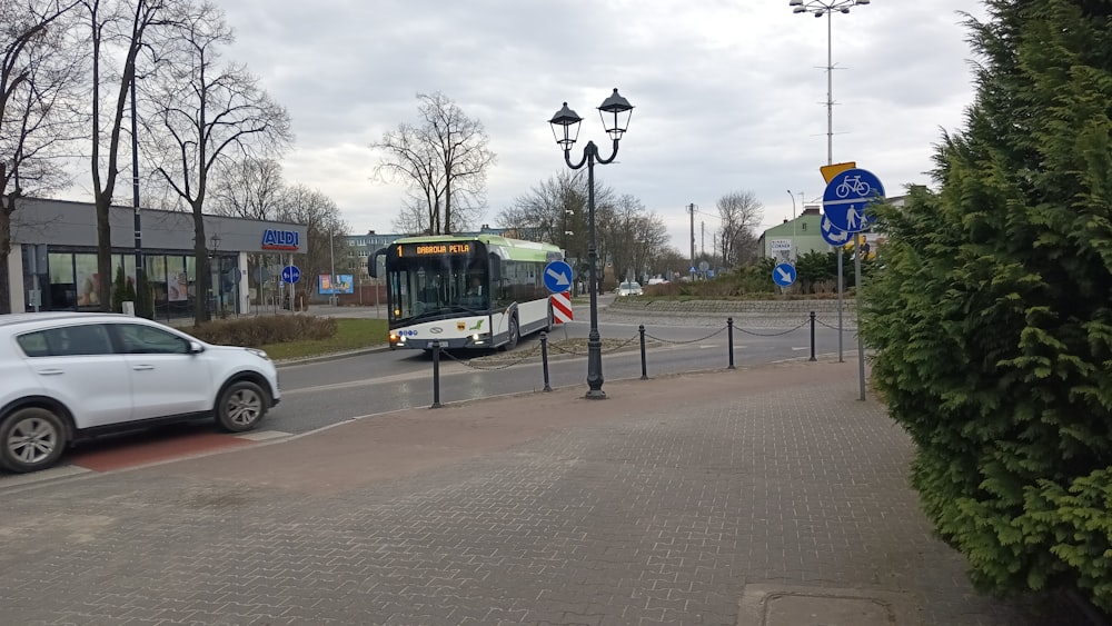 a bus is driving down the street near a car