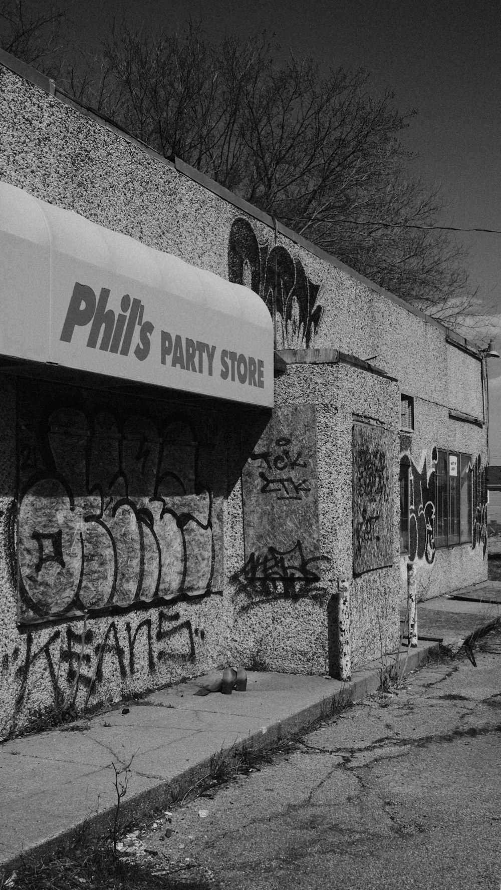 a black and white photo of a building with graffiti on it