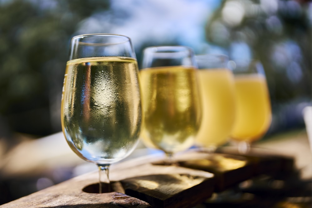 three glasses of champagne sitting on a wooden table