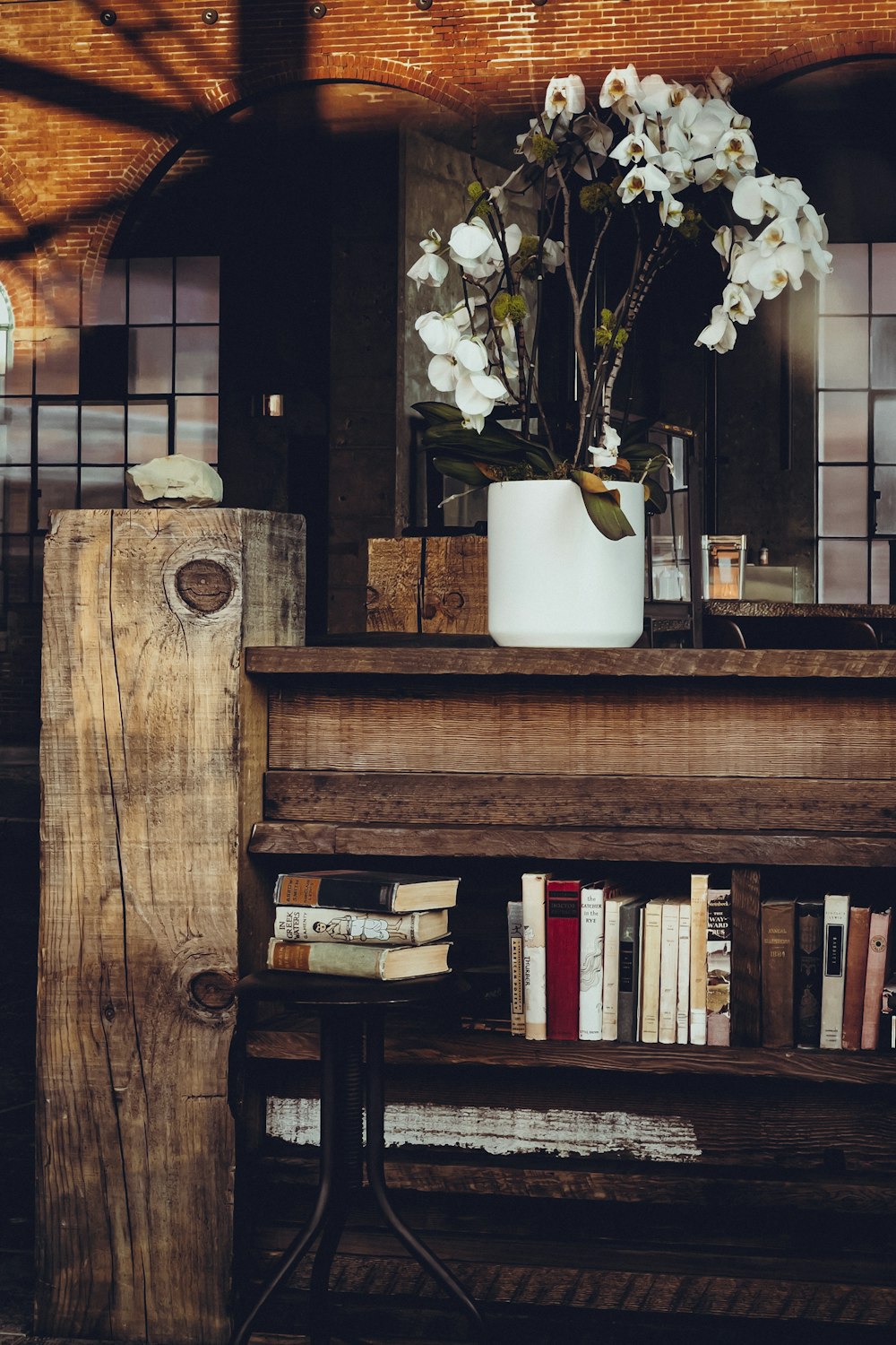 a wooden table topped with a vase filled with flowers