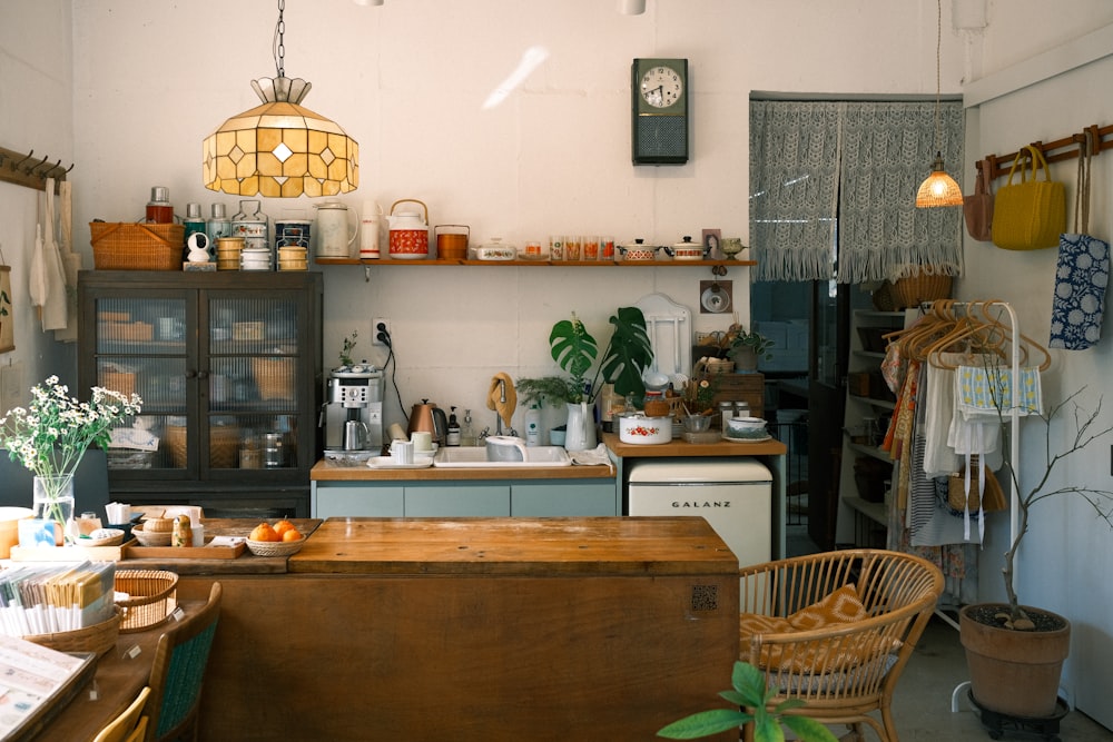 a kitchen filled with lots of clutter and furniture