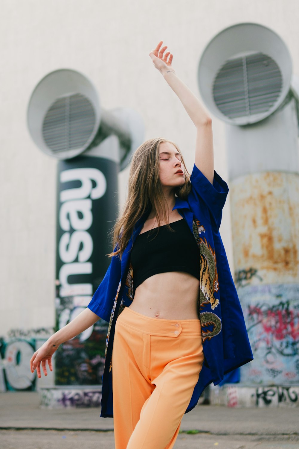 a woman in an orange pants and a blue jacket