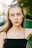 a woman with sunglasses on her head posing for a picture
