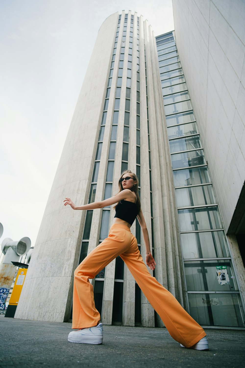 a woman standing in front of a tall building