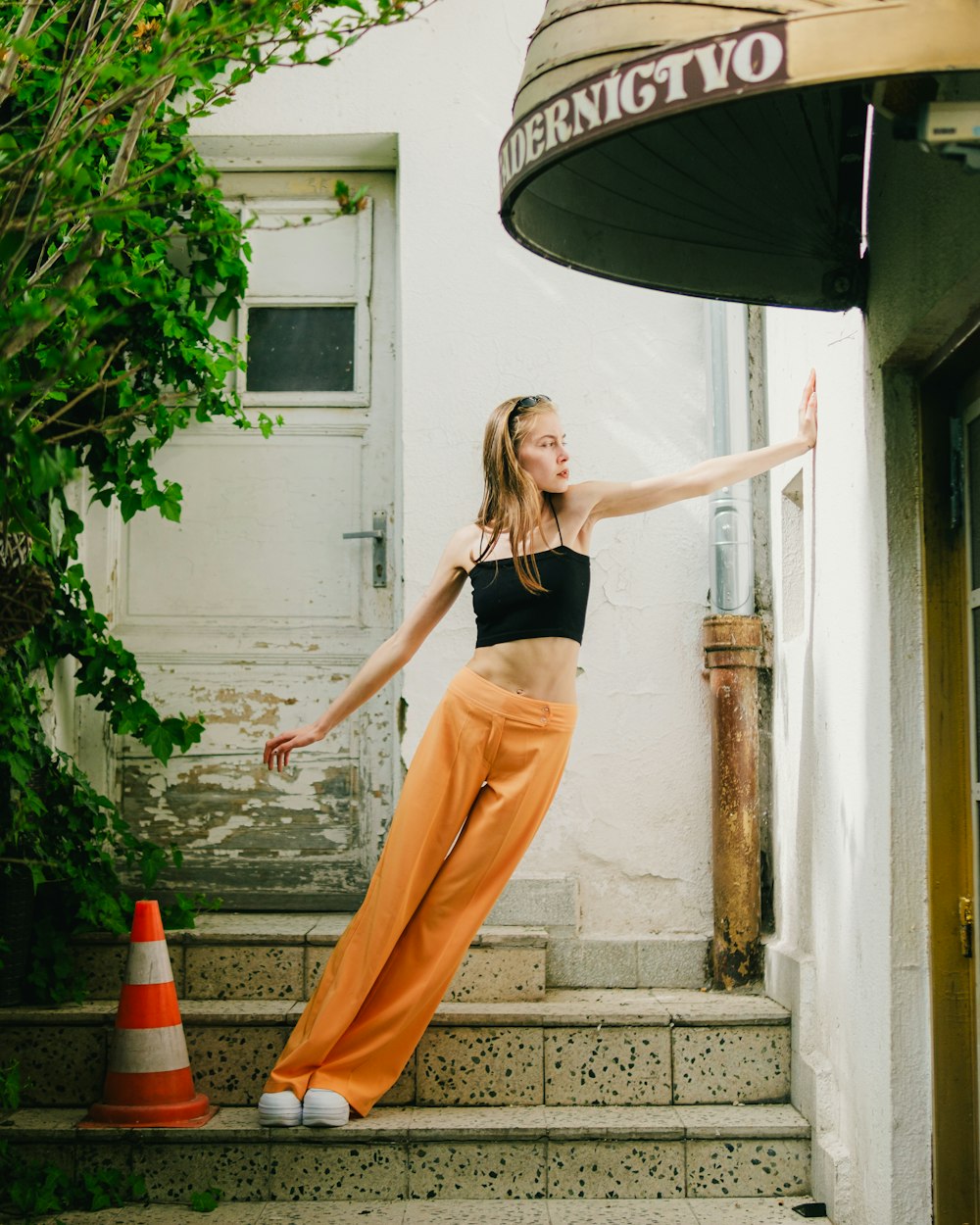 a woman is standing on the steps of a building