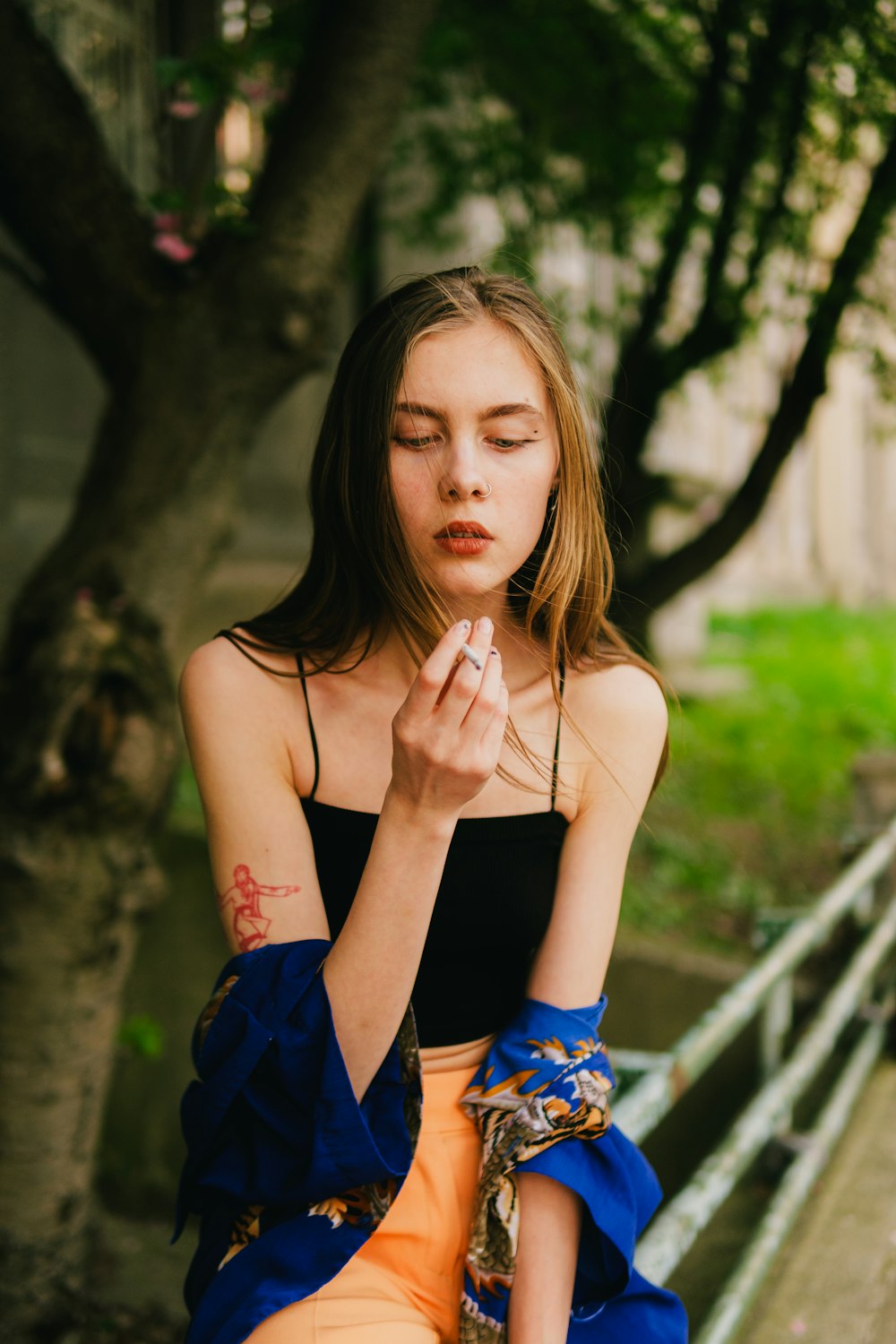 a woman sitting on a bench with her eyes closed