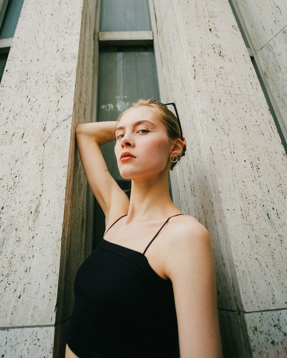 a woman standing in front of a tall building