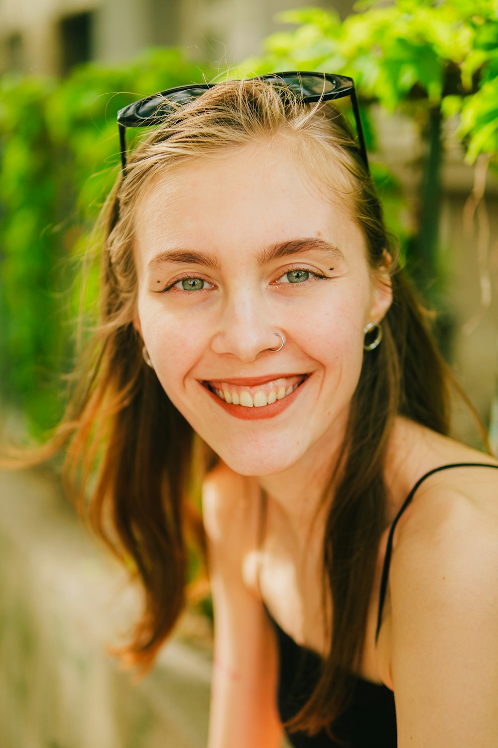 a woman with glasses smiling for the camera