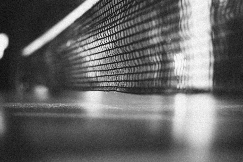 a black and white photo of a tennis net