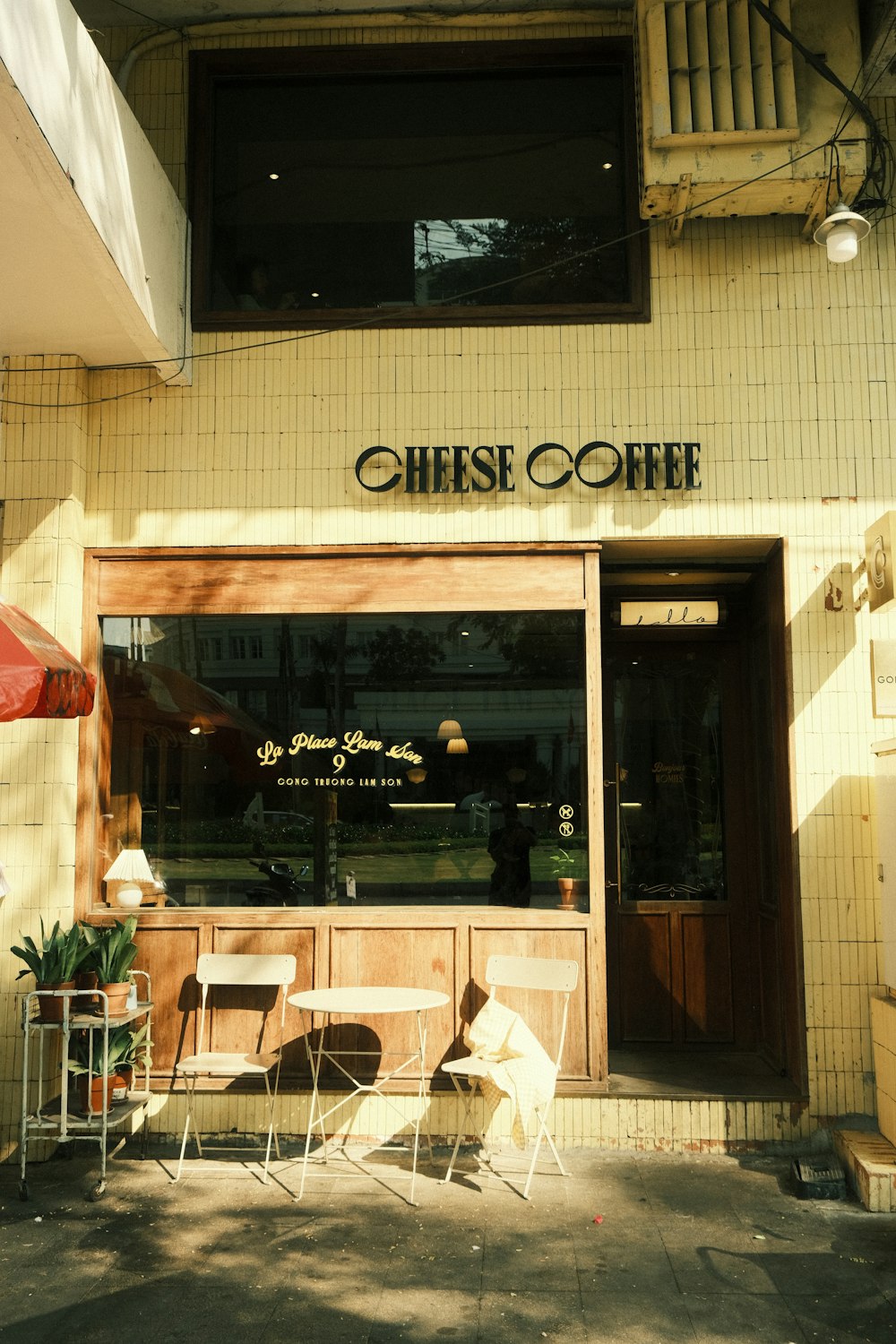 a coffee shop with tables and chairs outside